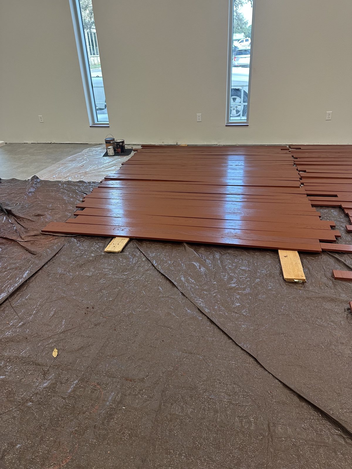 Stained plank stock laid out during an interior finish-out