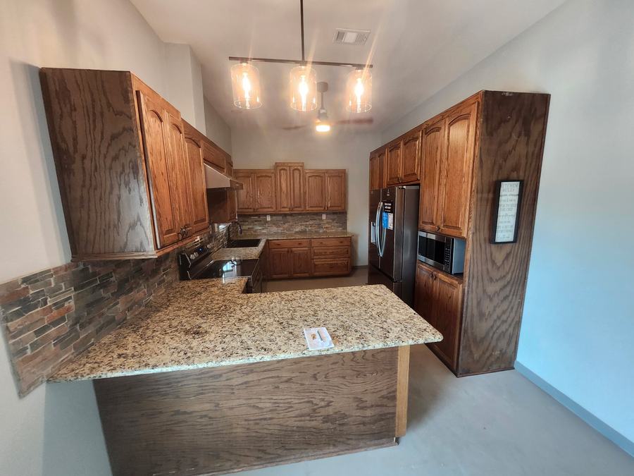 Custom oak kitchen with granite island in Dayton, Texas